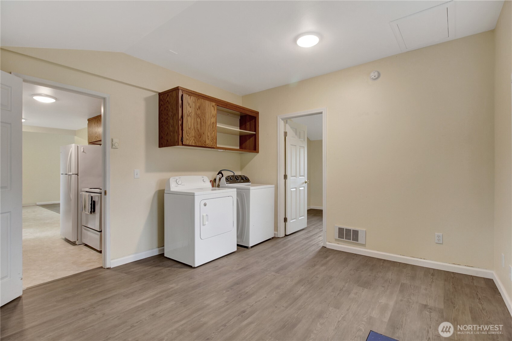 40018 May Creek Road Gold Bar, WA 98251 - Photo 11 of 25 a view of a kitchen with white cabinets and wooden floor
