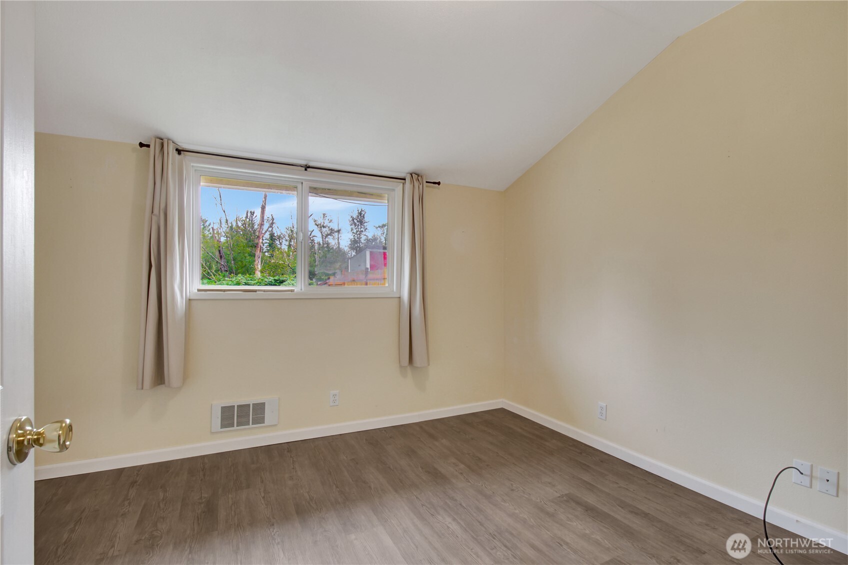 40018 May Creek Road Gold Bar, WA 98251 - Photo 12 of 25 an empty room with wooden floor and windows