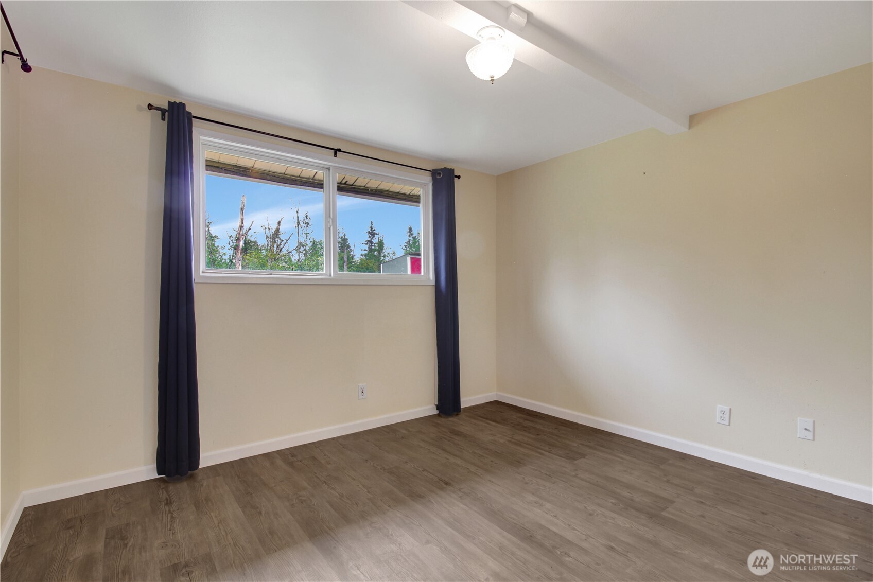 40018 May Creek Road Gold Bar, WA 98251 - Photo 17 of 25 an empty room with wooden floor and window