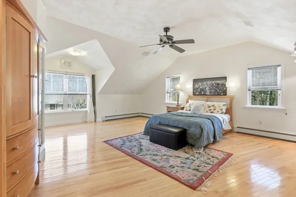 a bedroom with a large bed and a window