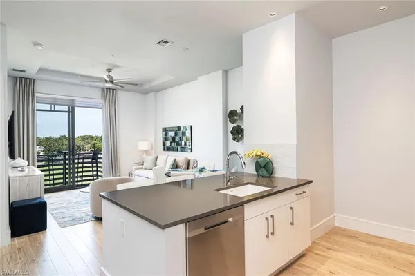 a kitchen with a sink a counter space and a window