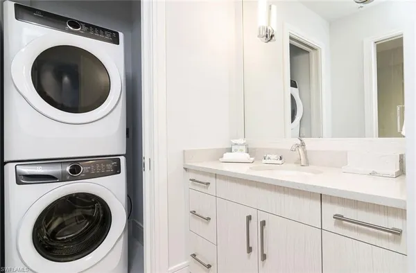 a utility room with sink dryer and washer