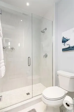 a bathroom with a toilet and a shower