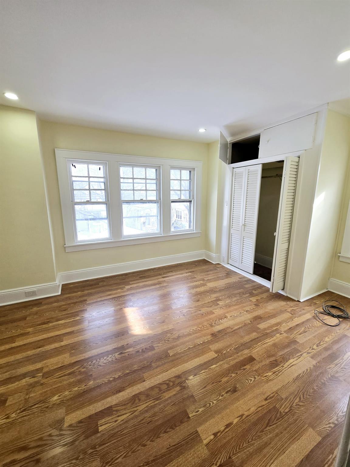 85-92 98th Street Queens, NY 11421 - Photo 2 of 8 Unfurnished room with dark hardwood / wood-style flooring