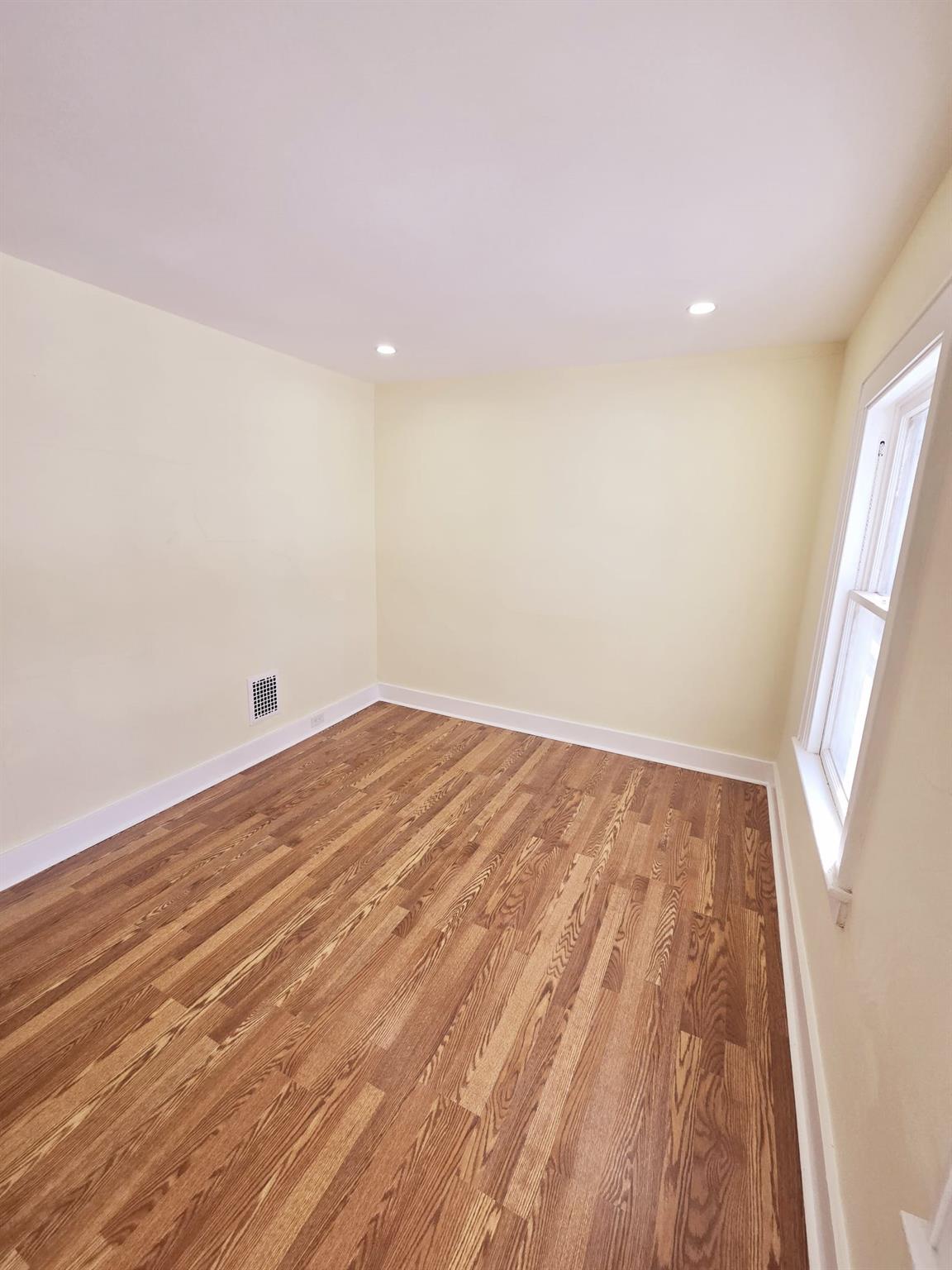 85-92 98th Street Queens, NY 11421 - Photo 3 of 8 Spare room featuring hardwood / wood-style floors