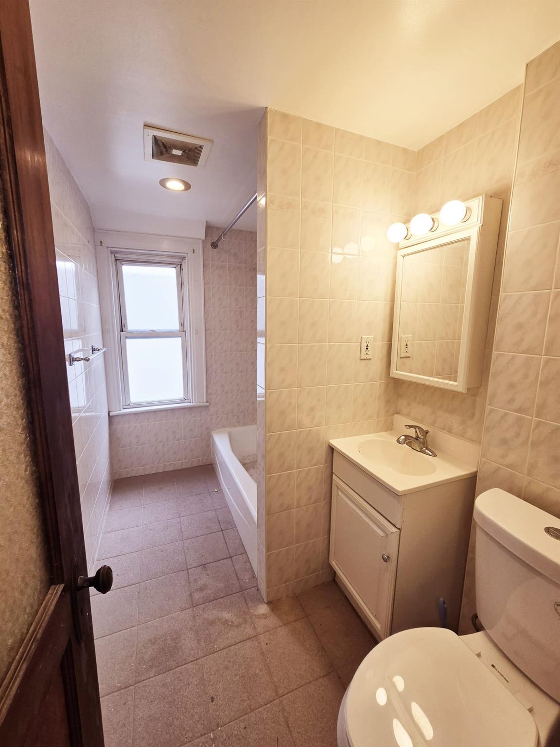 85-92 98th Street Queens, NY 11421 - Photo 5 of 8 Bathroom featuring toilet, vanity, and tile walls