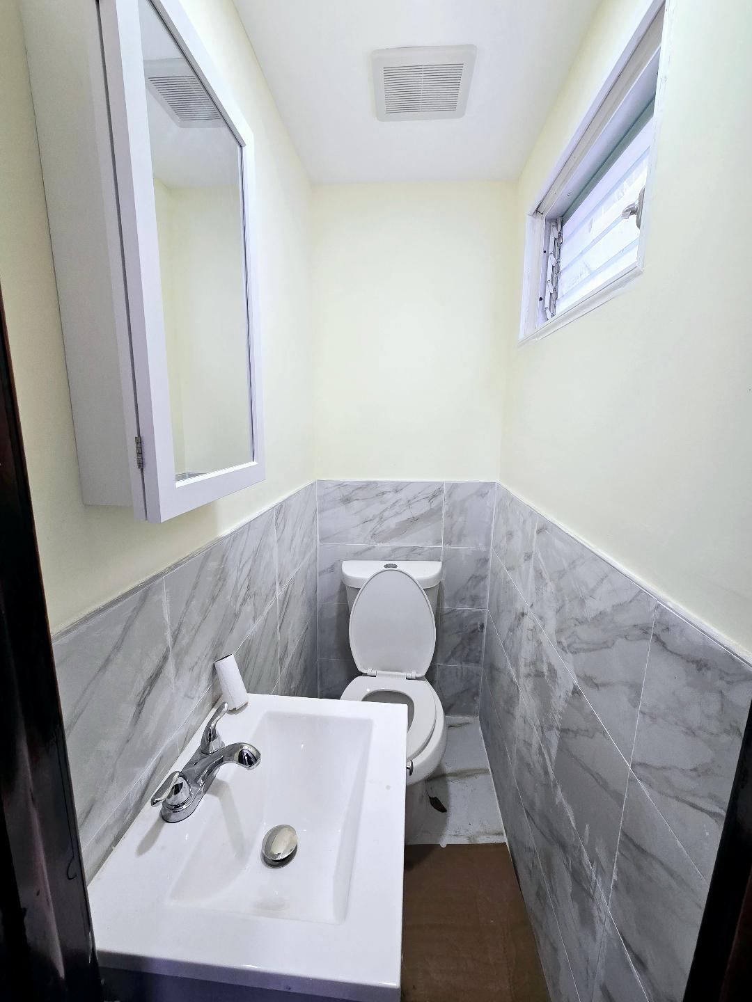 85-92 98th Street Queens, NY 11421 - Photo 6 of 8 Bathroom featuring toilet, tile walls, and sink