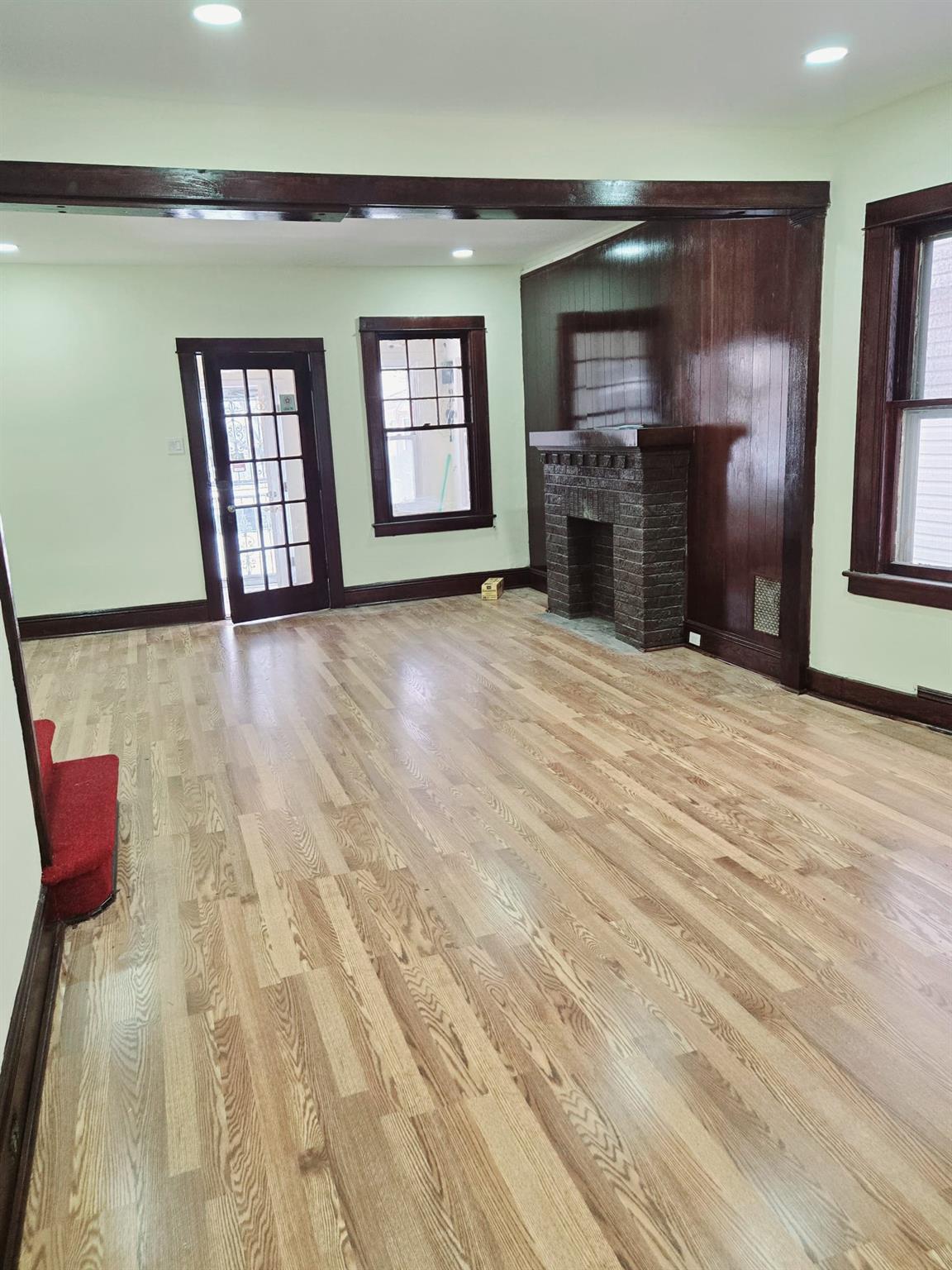 85-92 98th Street Queens, NY 11421 - Photo 7 of 8 Unfurnished living room with light hardwood / wood-style flooring and a fireplace