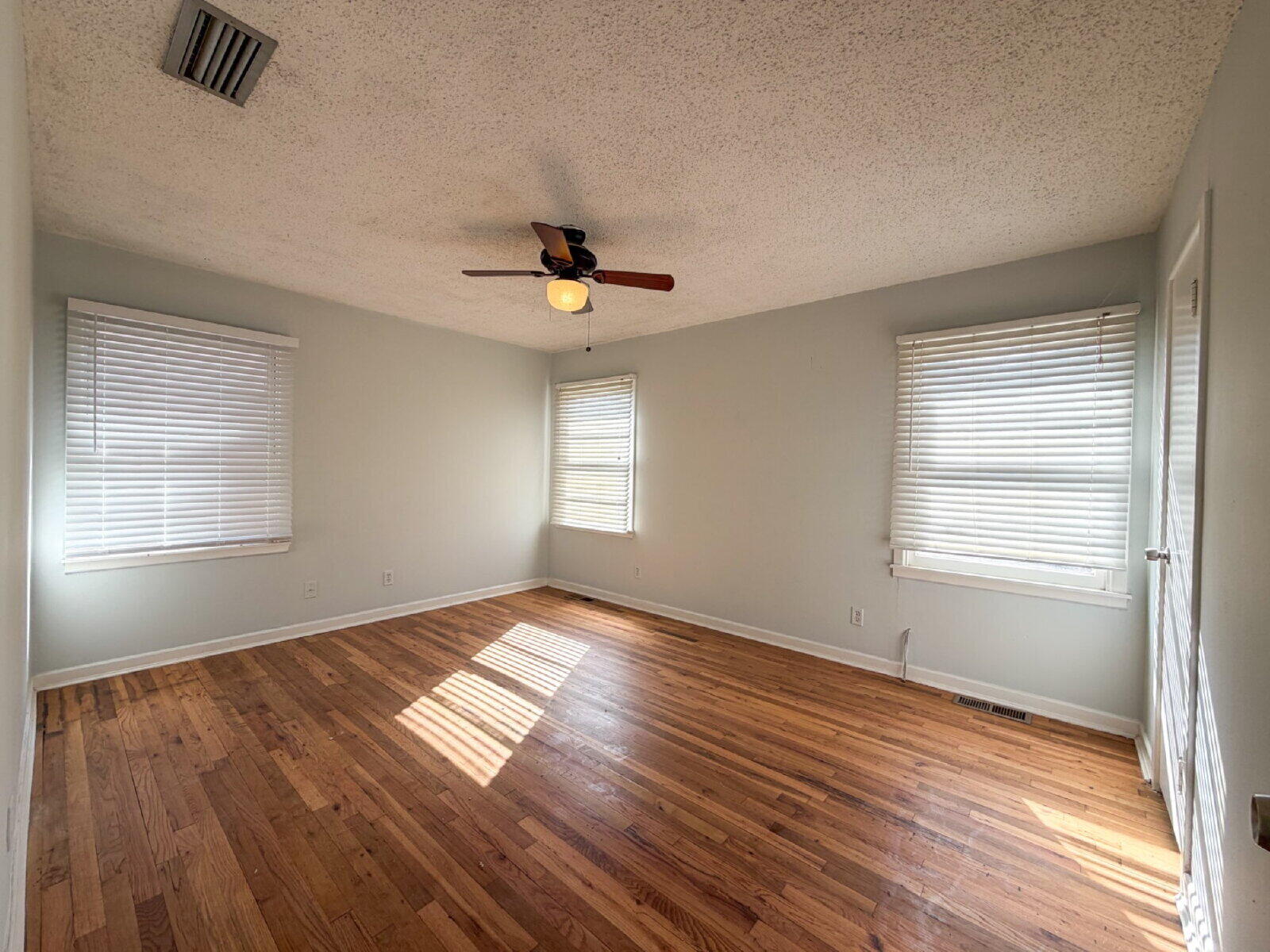 3415 35th Street Lubbock, TX 79413 - Photo 11 of 11 a view of an empty room with window and wooden floor