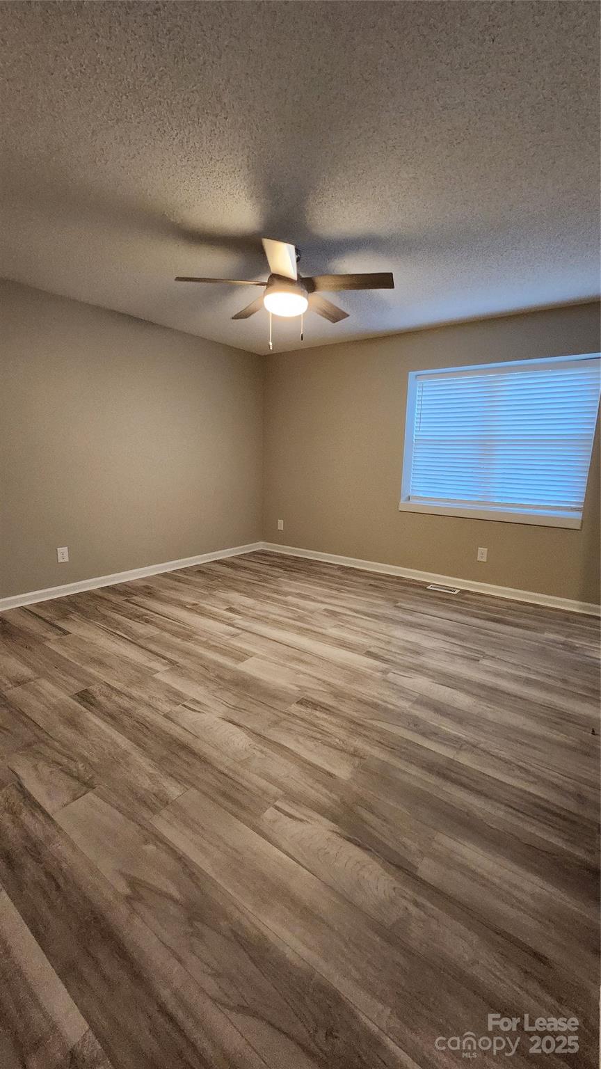 7505 Sarah Drive Denver, NC 28037 - Photo 9 of 13 a view of an empty room with window and a ceiling fan