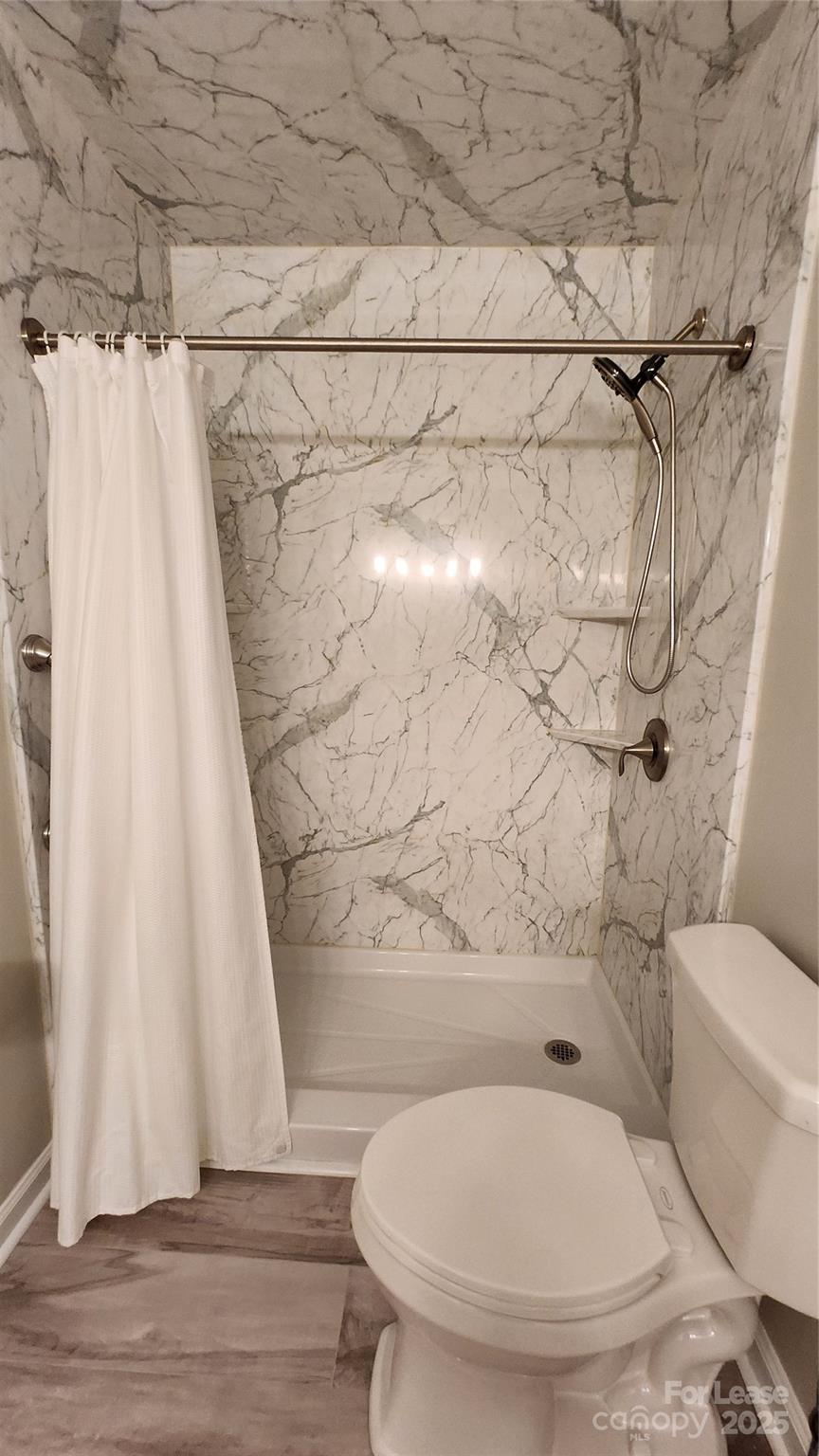 7505 Sarah Drive Denver, NC 28037 - Photo 10 of 13 a bathroom with a toilet and a shower