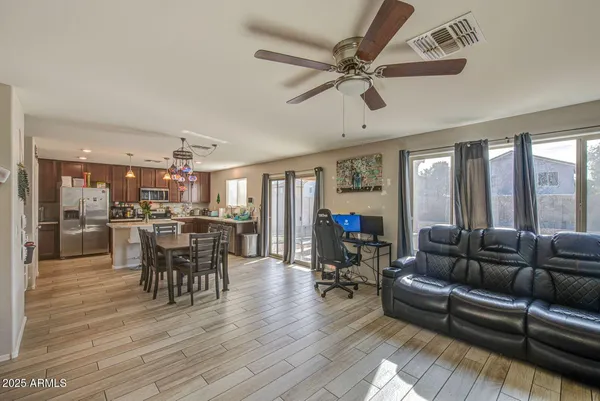 a living room with furniture and a wooden floor