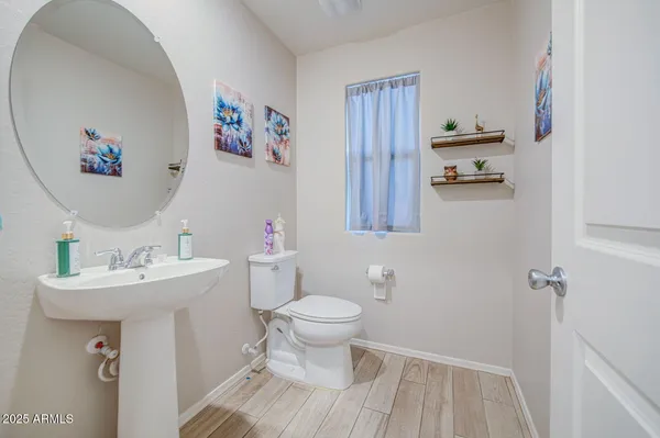 a bathroom with a sink mirror and toilet