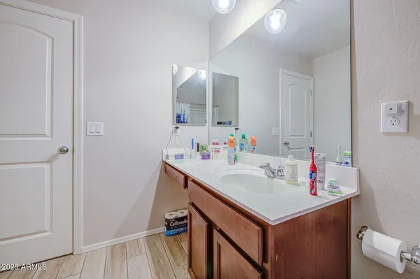 a bathroom with a sink vanity and a mirror