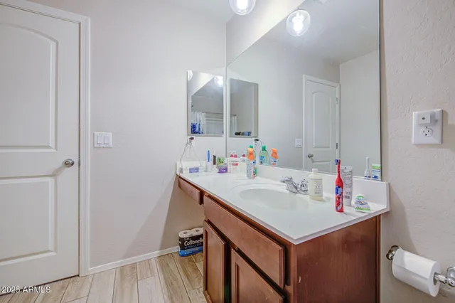 a bathroom with a sink vanity and a mirror