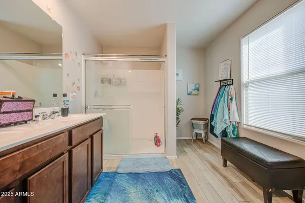 a bathroom with a sink a toilet and a shower