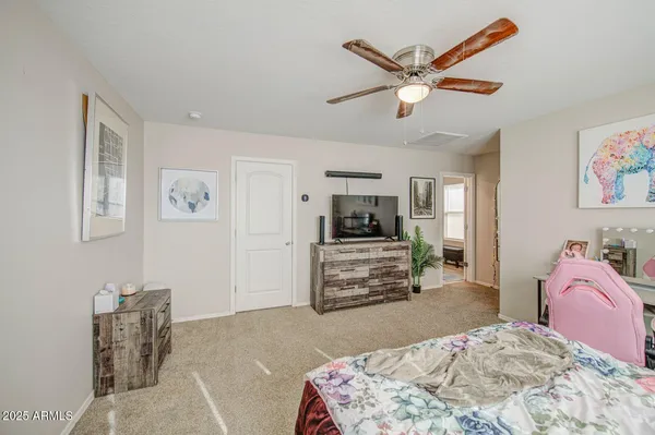 a bedroom with a bed and a chandelier
