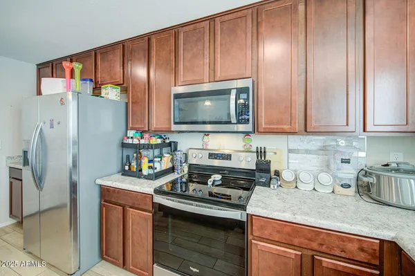 a kitchen with stainless steel appliances granite countertop a refrigerator stove and sink