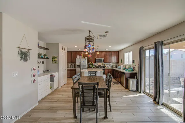 a view of a dining room kitchen with furniture and wooden floor