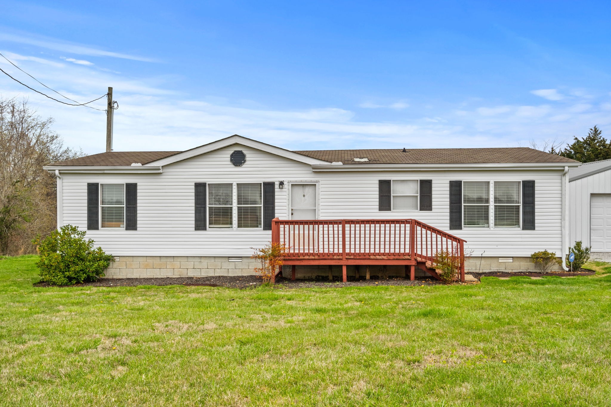 1848 Mint Springs Road Adams, TN 37010 - Photo 1 of 36 a front view of a house with a wooden deck and a yard