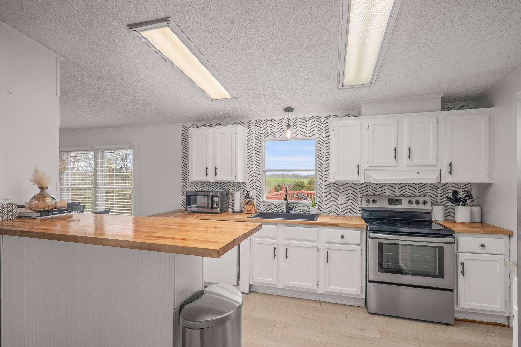 1848 Mint Springs Road Adams, TN 37010 - Photo 12 of 36 a kitchen with a sink stove and cabinets