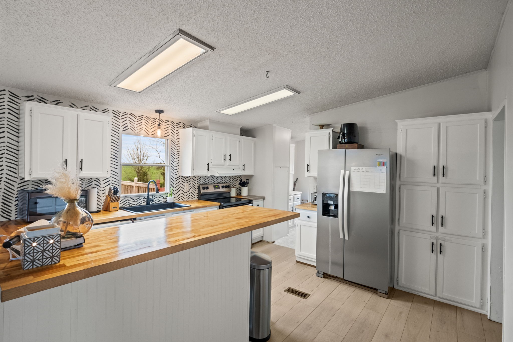 1848 Mint Springs Road Adams, TN 37010 - Photo 14 of 36 a kitchen with stainless steel appliances a refrigerator sink and cabinets