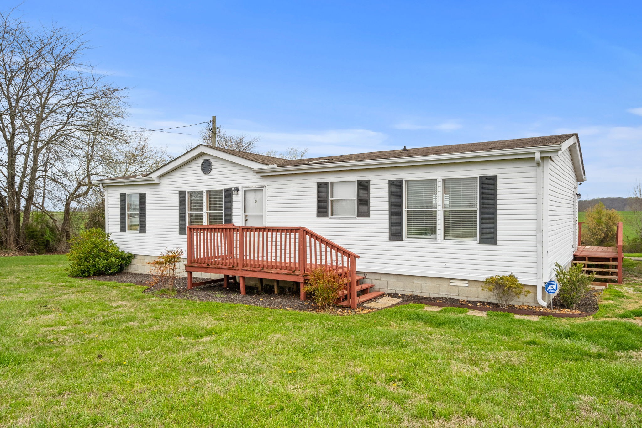 1848 Mint Springs Road Adams, TN 37010 - Photo 2 of 36 a view of a house with a backyard and deck