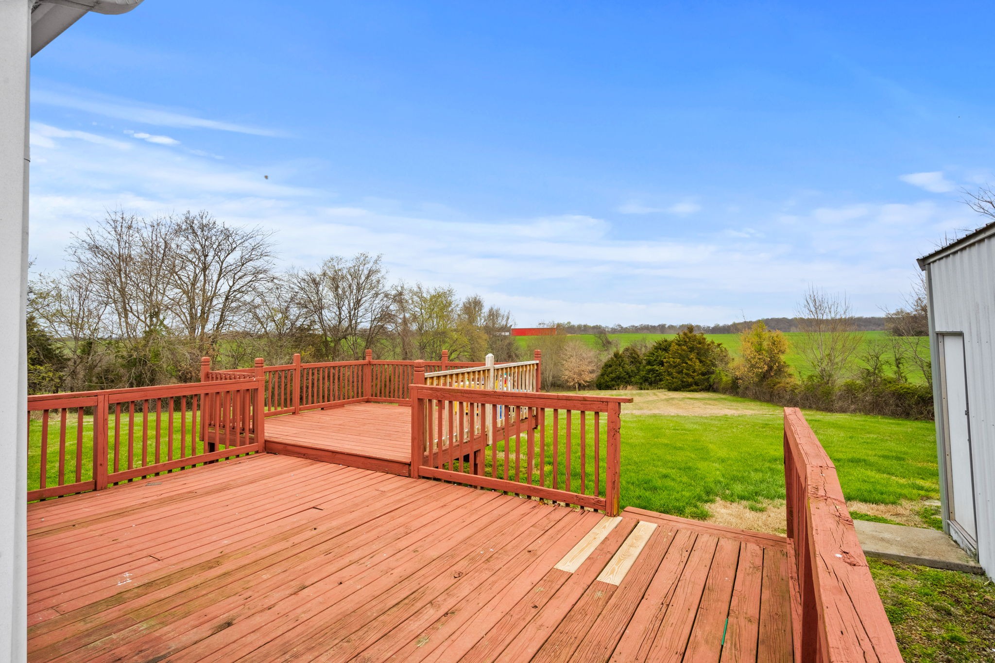 1848 Mint Springs Road Adams, TN 37010 - Photo 23 of 36 a view of deck with wooden floor and fence with a garden