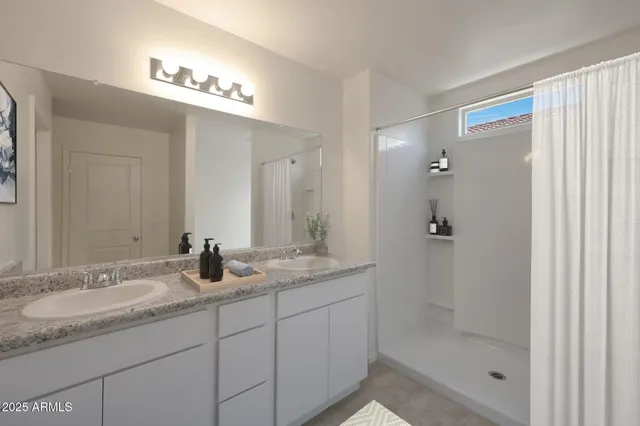 a bathroom with a granite countertop sink a shower and a mirror