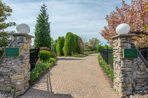 a front view of a house with a yard and a fountain