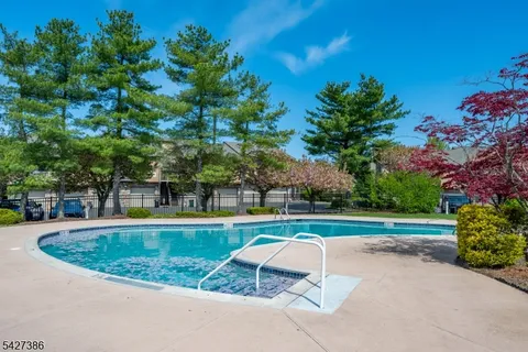 a view of backyard with swimming pool and outdoor seating