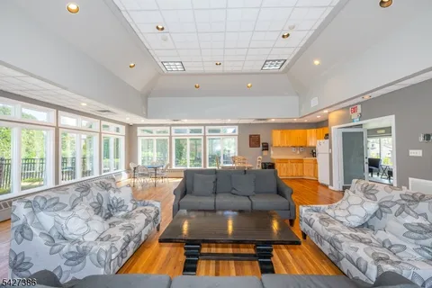 a room with furniture and large windows