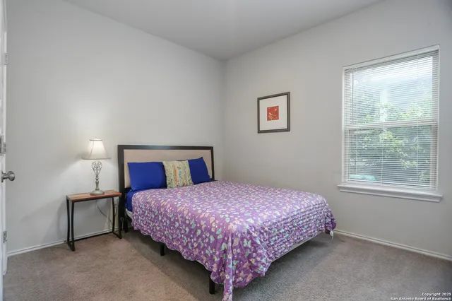 a bedroom with a bed and window