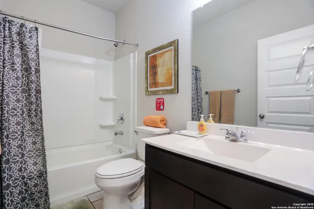 a bathroom with a sink toilet tub and shower