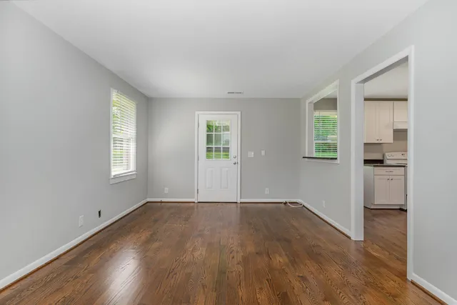 an empty room with windows and entrance