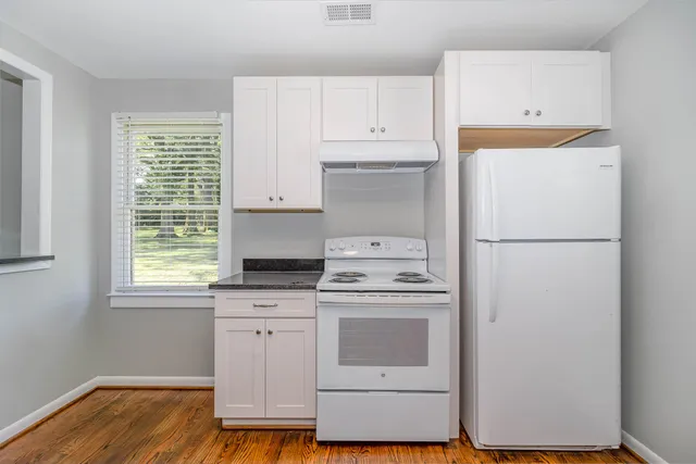 a kitchen with a stove a sink and a refrigerator