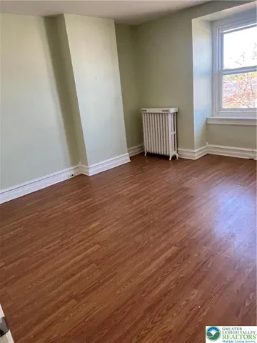 an empty room with wooden floor
