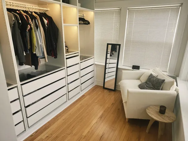 a view of walk in closet with clothes and shoes