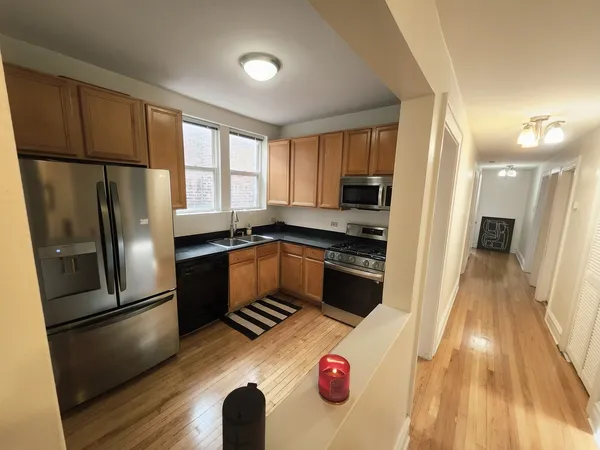 a kitchen with a refrigerator and a stove top oven