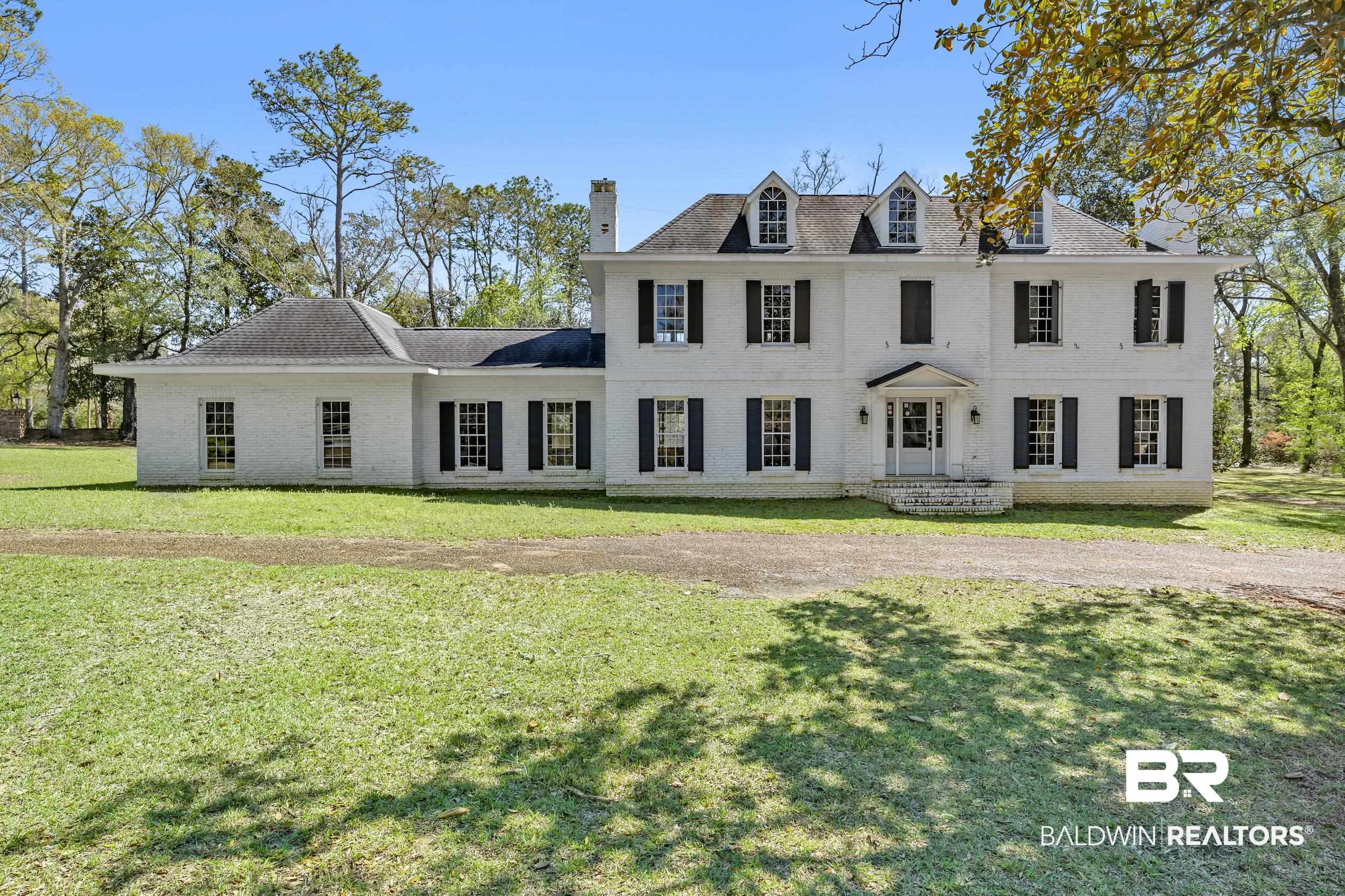 5801 South Fairfax Road Mobile, AL 36608 - Photo 1 of 29 Colonial-style house featuring brick siding, a front lawn, and a chimney