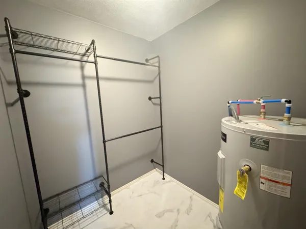 a view of a room with wooden floor and white walls