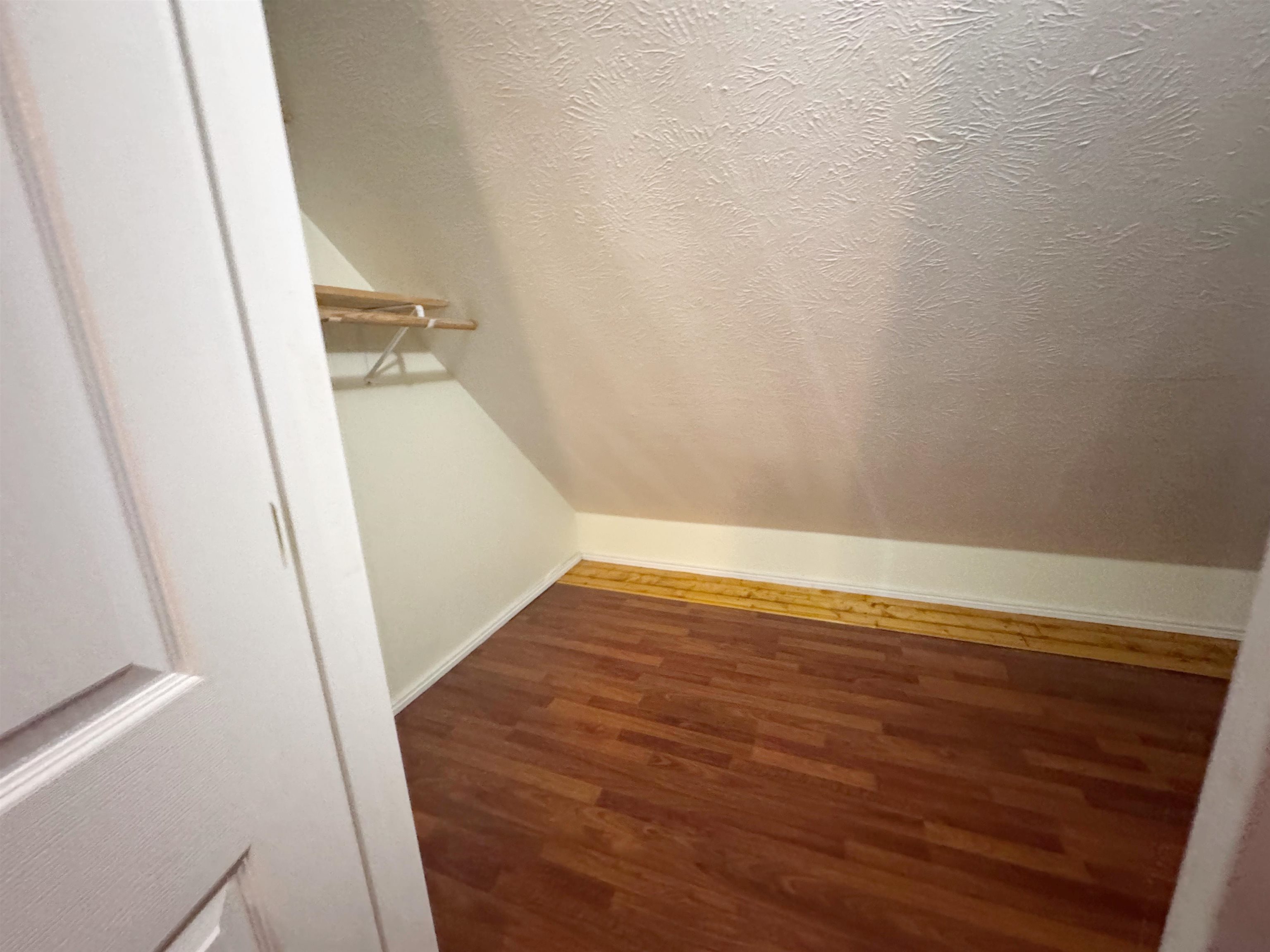 112 York Commons Ripley, TN 38063 - Photo 20 of 29 an empty room with wooden floor and white walls