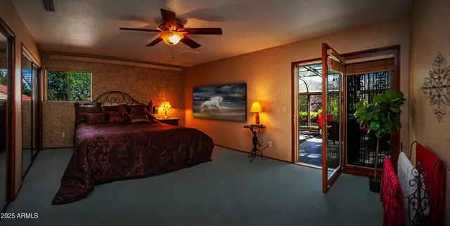 a bedroom with a bed and a chandelier