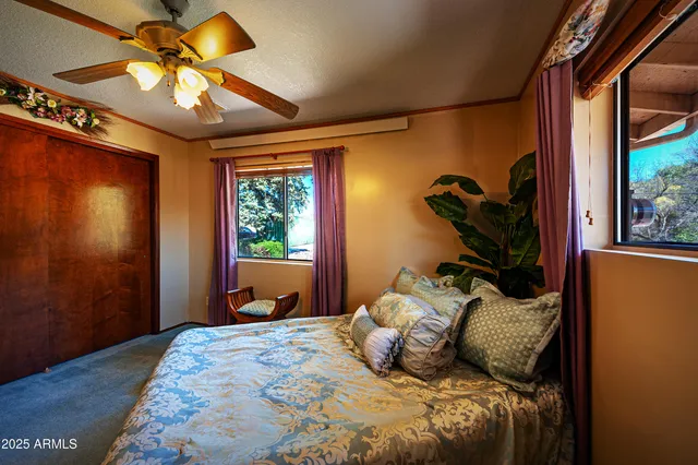 a bedroom with a bed and a potted plant