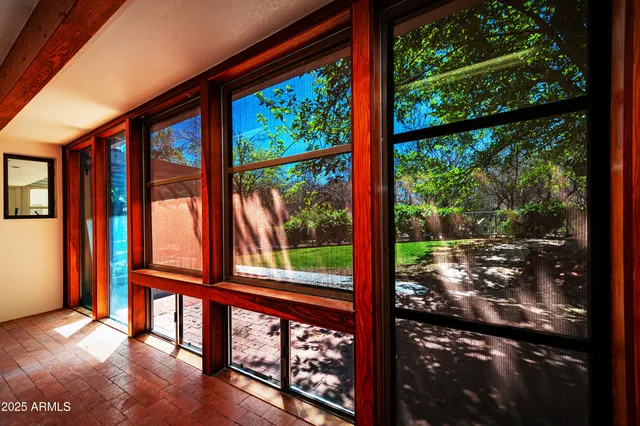 a patio with a table and chairs under an umbrella