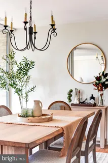 a living room with furniture a large window and wooden floor