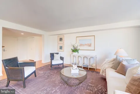 a view of a living room with a large window and wooden floor