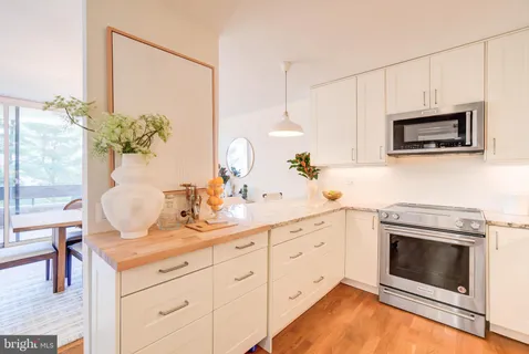 a bathroom with a granite countertop sink and a large mirror