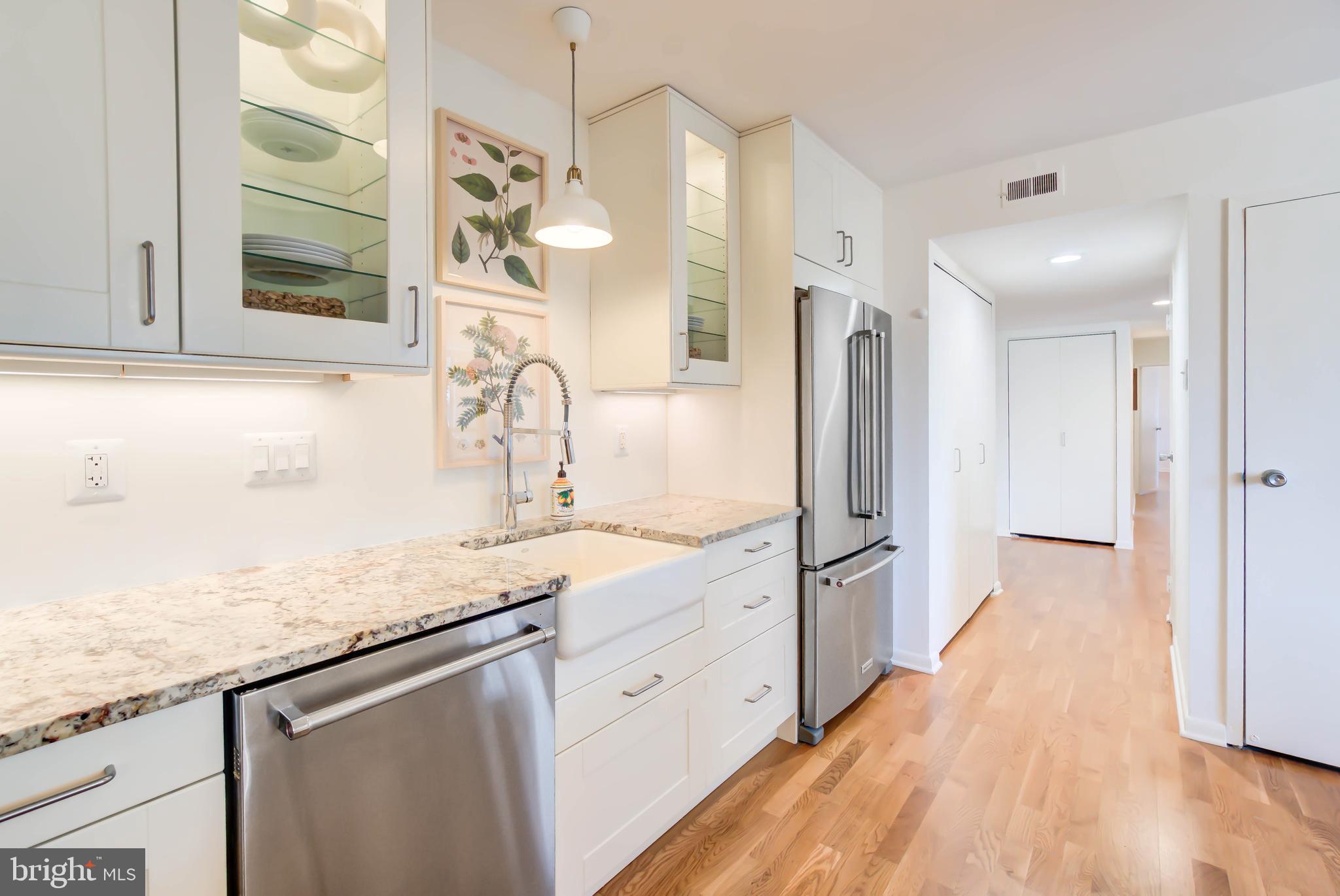 4936 Sentinel Drive, Unit 302 Bethesda, MD 20816 - Photo 5 of 52 Elegant Farmhouse Sink and Glass Cabinets
