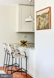 a living room with furniture a window and a potted plant